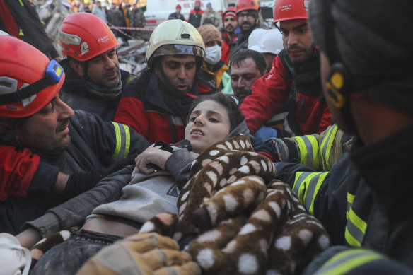 Rescuers carry Muhammed Alkanaas, 12, to an ambulance after they pulled him out five days after the earthquake in Antakya.