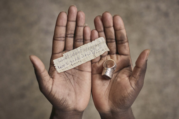 A Mauritanian migrant who crossed the US southern border shows the address of a Manhattan shelter he kept in the compartment of a ring during his journey.