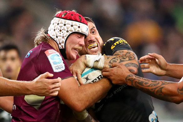 Fraser McReight and TJ Perenara wrestling with the ball.