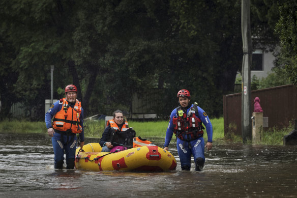 SES teams rescue Simone Baluch, her dog and a litter of kittens from a property in Chipping Norton on Thursday. 