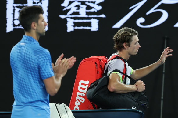 Novak Djokovic applauds as Alex de Minaur leaves Rod Laver Arena.