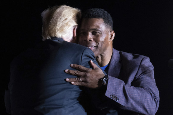 Former President Donald Trump hugs Georgia Senate candidate Herschel Walker in September.