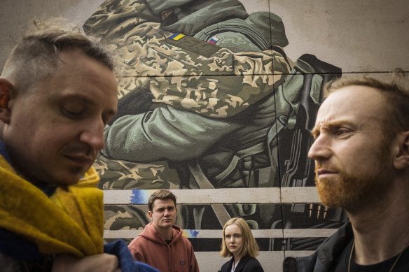 Members of Melbourne’s Ukrainian community (from left) Danylo Stefyn, Bohdan Cherednyk, Hanna Ilina and Stefan Bugryn near the Peter Seaton mural on Sunday before it was painted over.