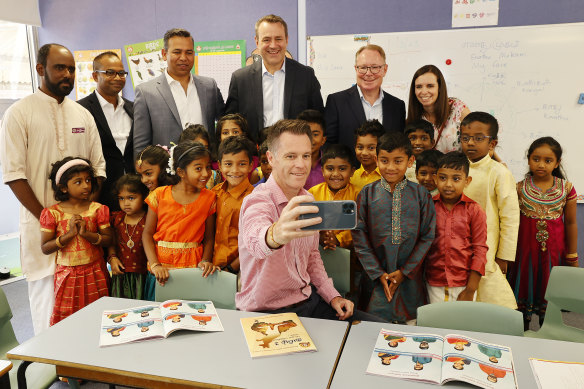 Labor leader Chris Minns with children from the Wentworthville Tamil school with local MP for Prospect, Hugh McDermott, second from right, and shadow minister for better regulation and innovation Courtney Houssos, right.