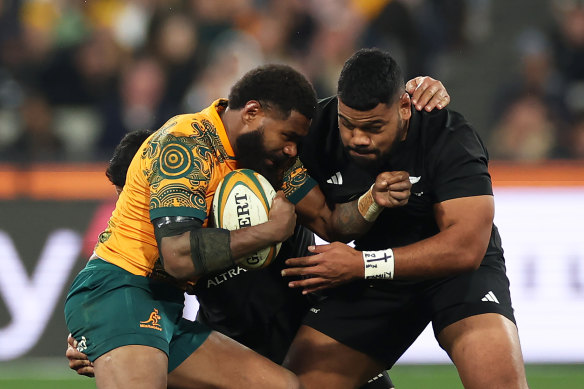 Marika Koroibete of the Wallabies competes for the ball against  Samisoni Taukei’aho of the All Blacks.