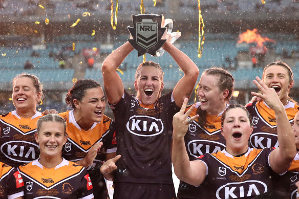 Ali Brigginshaw and the Broncos lift the NRLW premiership trophy.