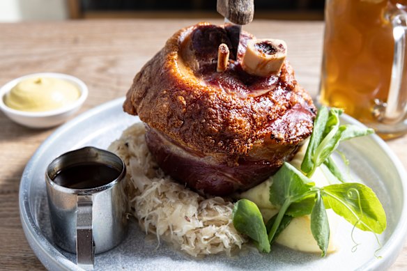 Pork knuckle with sauerkraut, hot mustard, mash and Dunkel-Bier sauce.