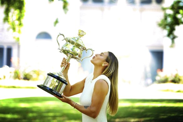 Aryna Sabalenka poses with the Daphne Akhurst Memorial Cup at the sun-drenched Carlton Gardens after her win in January.