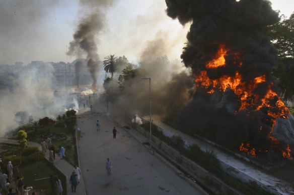 Angry Imran Khan supporters set fires during a protest against his arrest on Tuesday. Police used tear gas to disperse them.