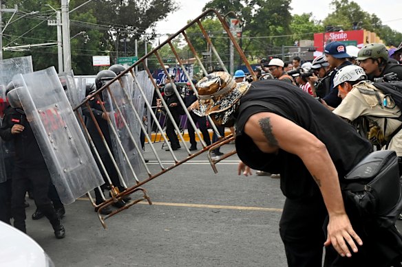 Police and protesters clash.
