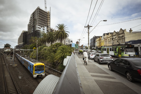 The area surrounding Malvern station has older low-rise buildings on one side, and a new tower under co<em></em>nstruction opposite.