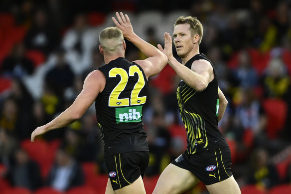 Jack Riewoldt is congratulated after kicking a goal in the Tigers’ win.