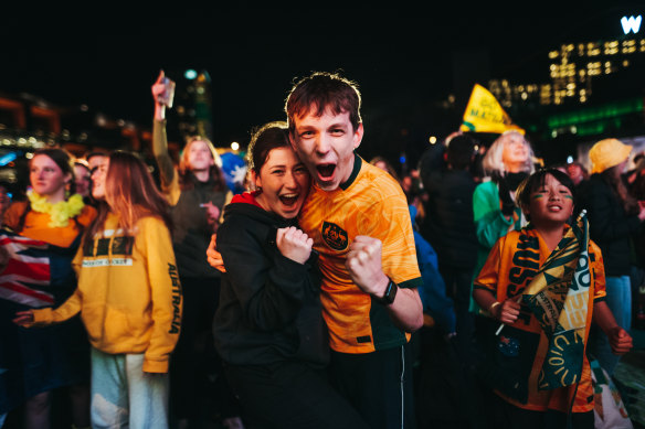 Fans at Tumbalong Park celebrate a Matildas goal on August 16. 