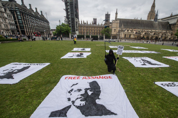 Banners are laid out as a protest picnic demanding the release of Julian Assange is held on his 50th birthday at Parliament Square in London last weekend