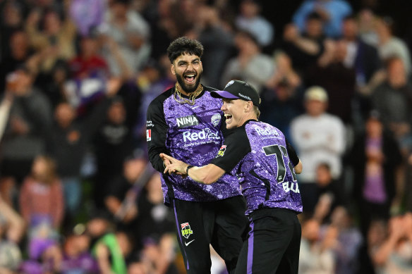Nathan Ellis and Nikhil Chaudhary celebrate the Hurricanes’ 12-run win over the Sixers on Tuesday evening.