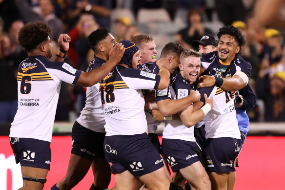 Ryan Lonergan is mobbed by Brumbies teammates after his match-winning kick.