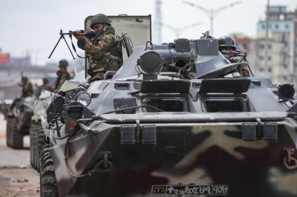 Bangladeshi military forces on armoured vehicles patrol on the streets of Dhaka last month.