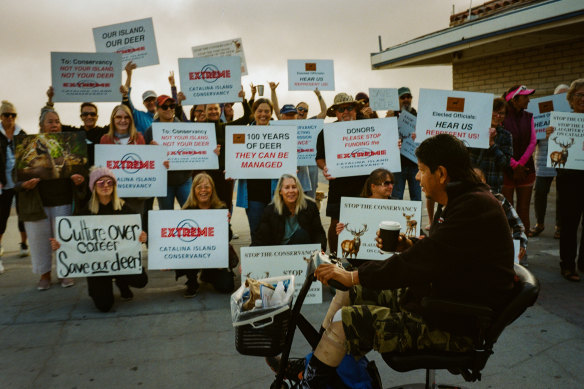 Avalon residents who learned of the arrival of journalists from The New York Times demonstrate at the ferry terminal for the California coastal island of Santa Catalina.