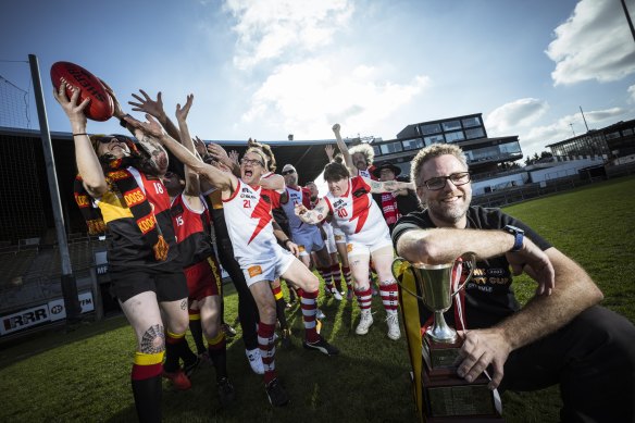 Reclink CEO Dave Wells in the foreground as the Megahertz and Rockdogs fly for a mark in preparation for the Community Cup. 