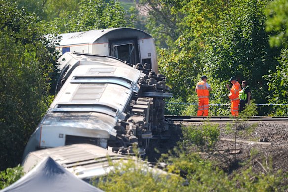 Members of the Rail Accident Investigations Bureau (RAIB) on the tracks at the scene where a train derailed near Lewes railway station in East Sussex.