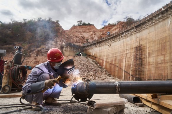 An employee of China Water & Electric Corp welds pipework at the construction site of the Gwayi-Shangani dam, 245km north-west of Bulawayo, Zimbabwe, in June.