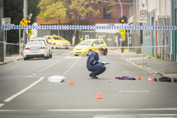 A forensic police officer examines the scene outside Love Machine.