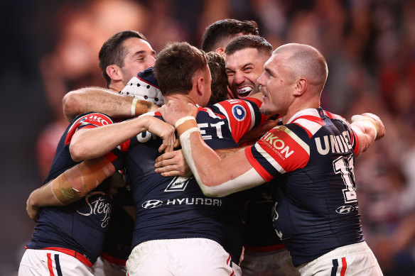 The Roosters celebrate a try.