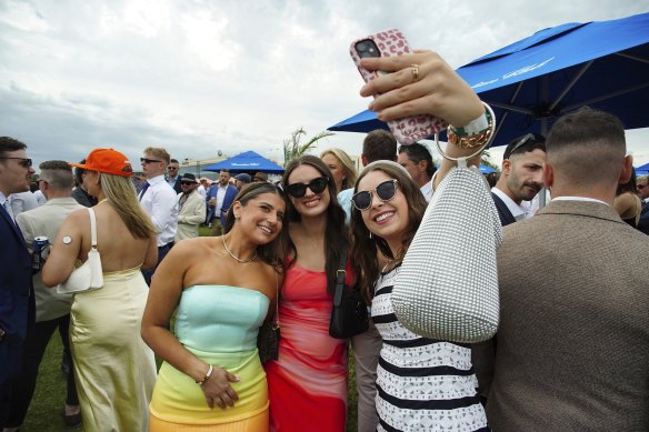 Racegoers take a quick selfie at Caulfield Cup.