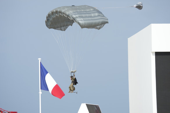 A paratrooper arrives during an international ceremony to mark the 80th anniversary of D-Day, in Normandy, France.