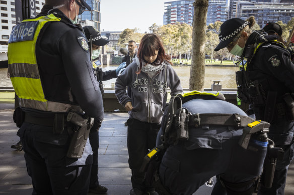 A protester is searched during Thursday’s demonstration in Southbank.