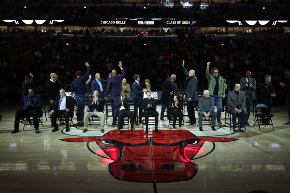 Luc Longley (green jacket) and members of the 1996 Bulls side are presented to the crowd at a Ring Of Honor ceremony at the United Center on January 12. 