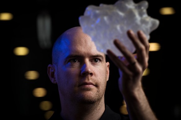 Bureau of Meteorology thunderstorm research scientist Dr Joshua Soderholm with a 3D replica of the world’s largest hailstone, which measured more than 20 centimetres in diameter.