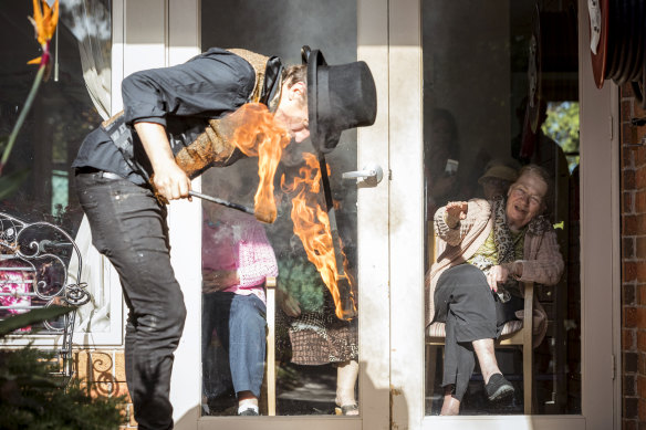 Fire performer Chris James and resident Maggie Goller during the window show at Lifeview's aged care home The Willows.