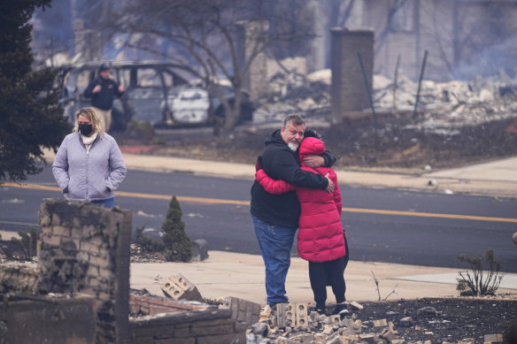 Renato D’Amario hugs neighbor Lori Peer after finding their homes destroyed in Louisville, Colorado. 