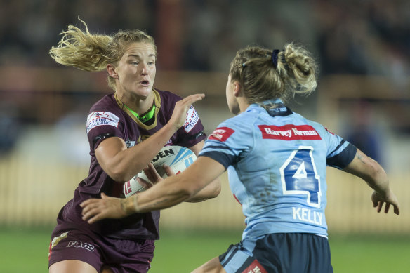 Queensland's Meg Ward is tackled by NSW's Isabelle Kelly during last year's Women's State of Origin match.