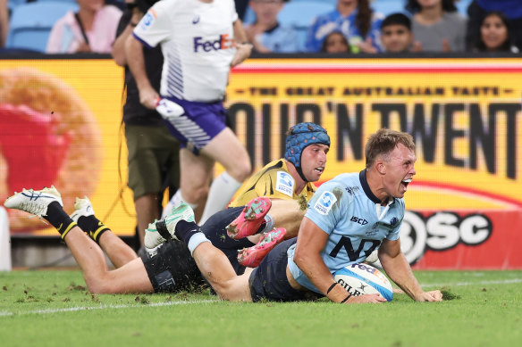 Darby Lancaster celebrates scoring a try.