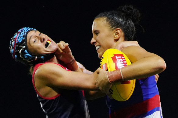 Melbourne's Aliesha Newman tackles Bailey Hunt of the Bulldogs.