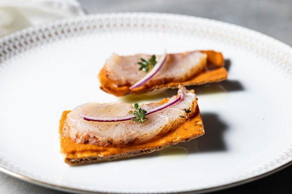 Tostadas topped with salt-cured kingfish pancetta and mojo rojo.