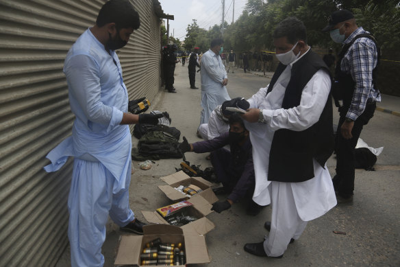 Security personnel examine confiscated ammunition from attackers outside the stock exchange.