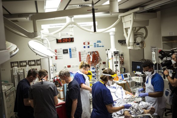 The emergency team treat a patient at the Royal Melbourne Hospital. 