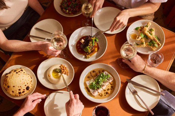 The food spread at Rafi Urbnsurf, including the braised lamb shoulder, steamed barramundi and sourdough wholemeal pita bread.