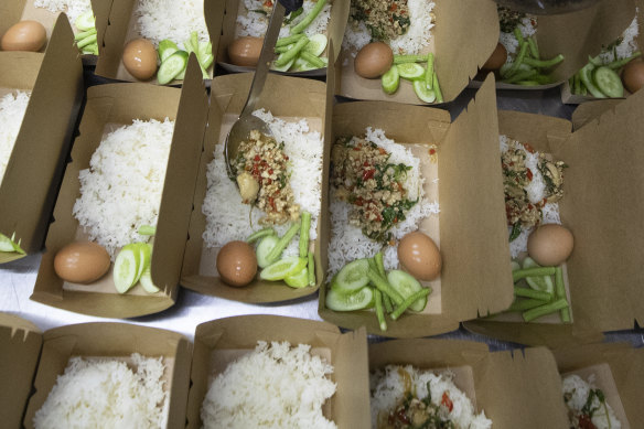 "Pad krapow gai",  the spicy minced chicken is filled in a box by volunteers at COVID Thailand Aid in Bangkok.