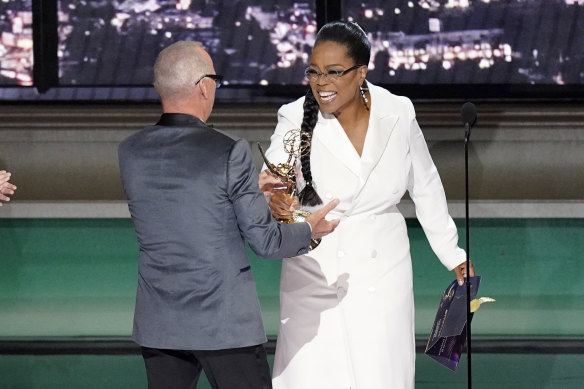 Oprah Winfrey, right, presents the Emmy for outstanding lead actor in a limited or anthology series or movie to Michael Keaton, left, for “Dopesick” at the 74th Primetime Emmy Awards