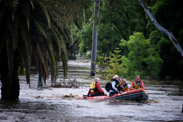 SES rescuers transport people on the Maribyrnong River.