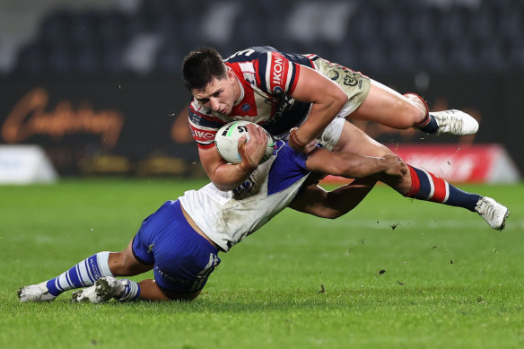 Victor Radley is tackled in midair at Bankstown Stadium.