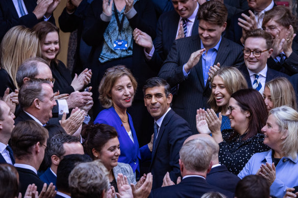 New Conservative Party leader and incoming prime minister Rishi Sunak is greeted by colleagues at the Conservative Party Headquarters.