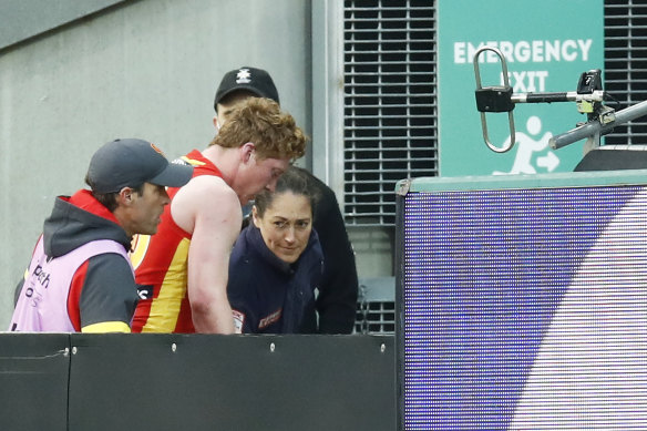Matt Rowell with the club's doctor after injuring his shoulder.