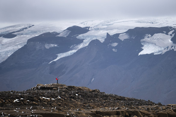 A man stops on his way to the top of what once was the Okjokull glacier in Iceland.