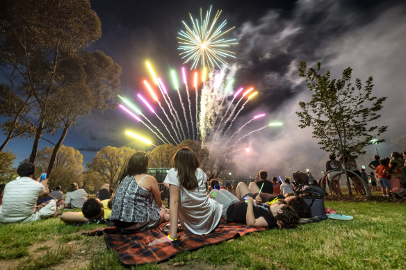 Families watch the New Year's Eve fireworks in Melbourne in 2015.