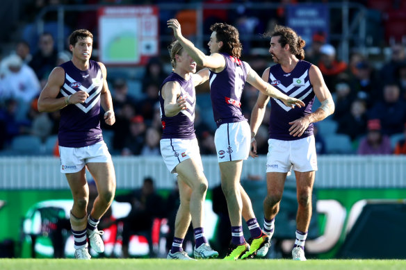 Jordan Clark and the Dockers celebrate a goal.